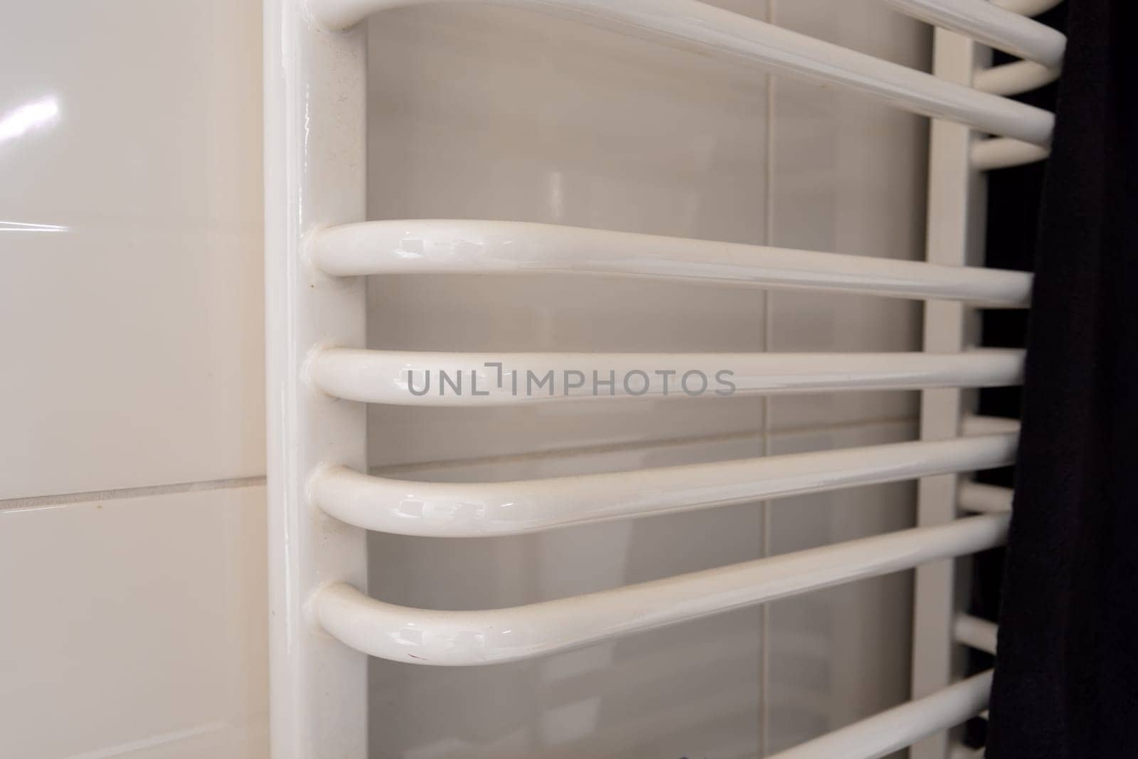 Large white ladder bathroom radiator and dark towel