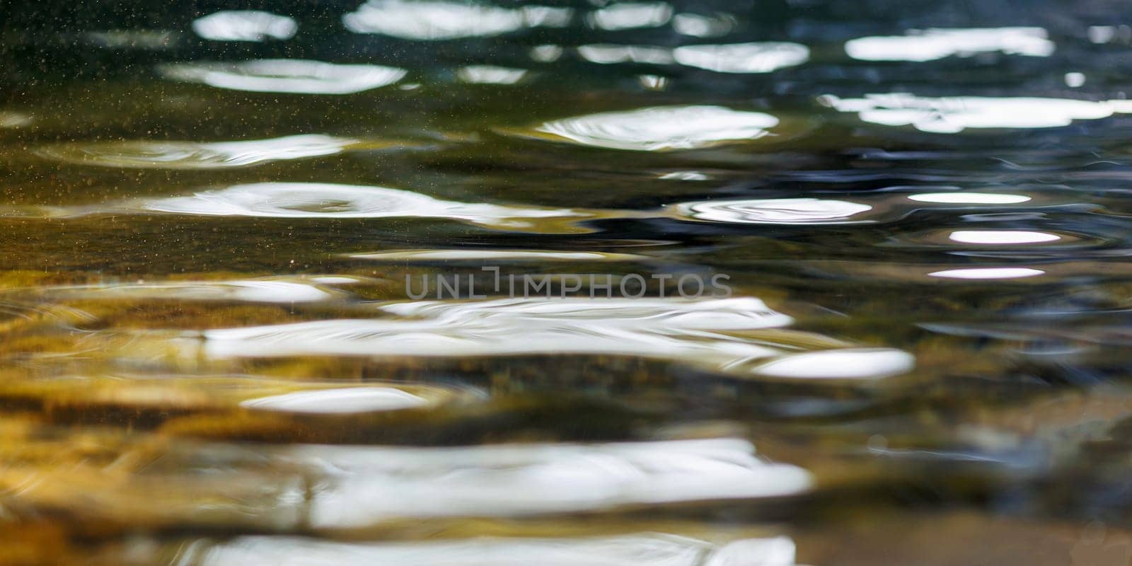 Transparent pure golden water in river