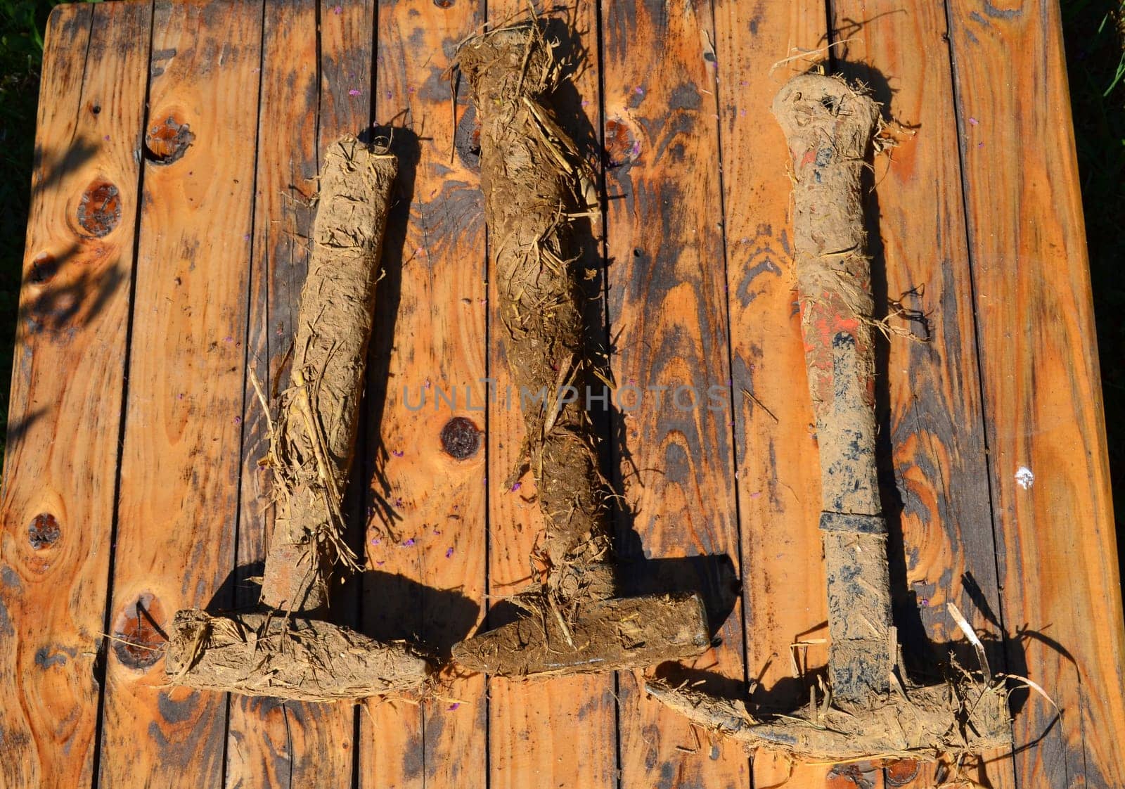 Dirty hammers of earth and straw used in construction with natural materials