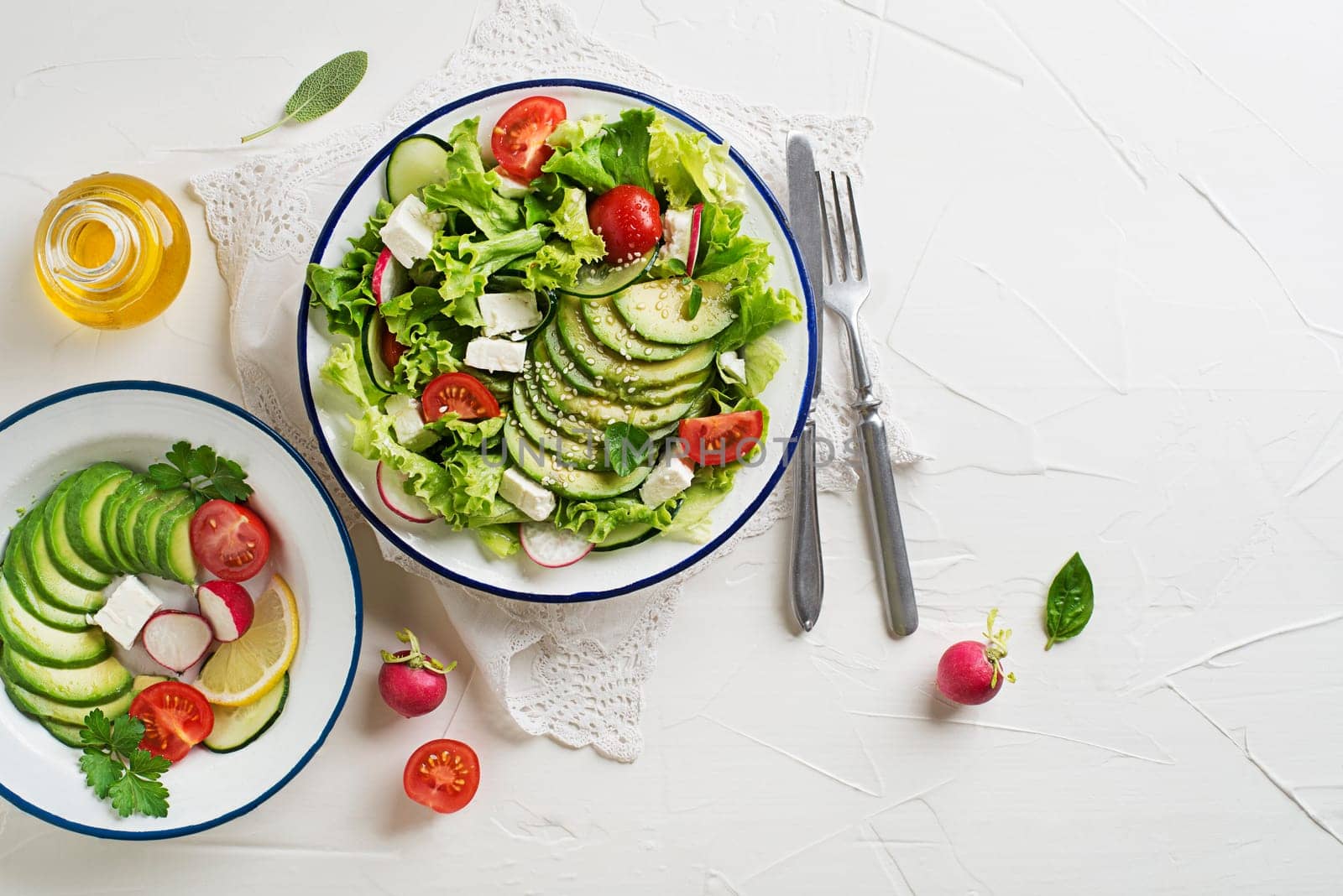 Green salad with avocado, tomato, feta cheese and fresh vegetables