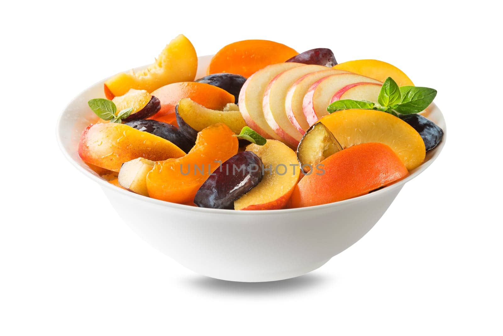 Bowl of healthy fresh fruit salad isolated on white background