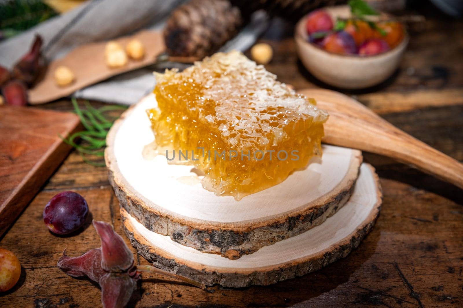 Piece of fresh honey cut with a knife on a traditional table