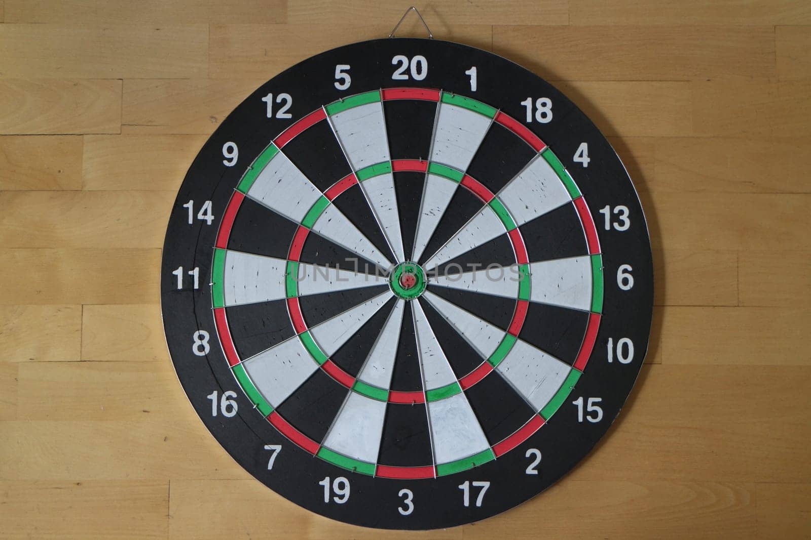 Target for playing darts wooden background