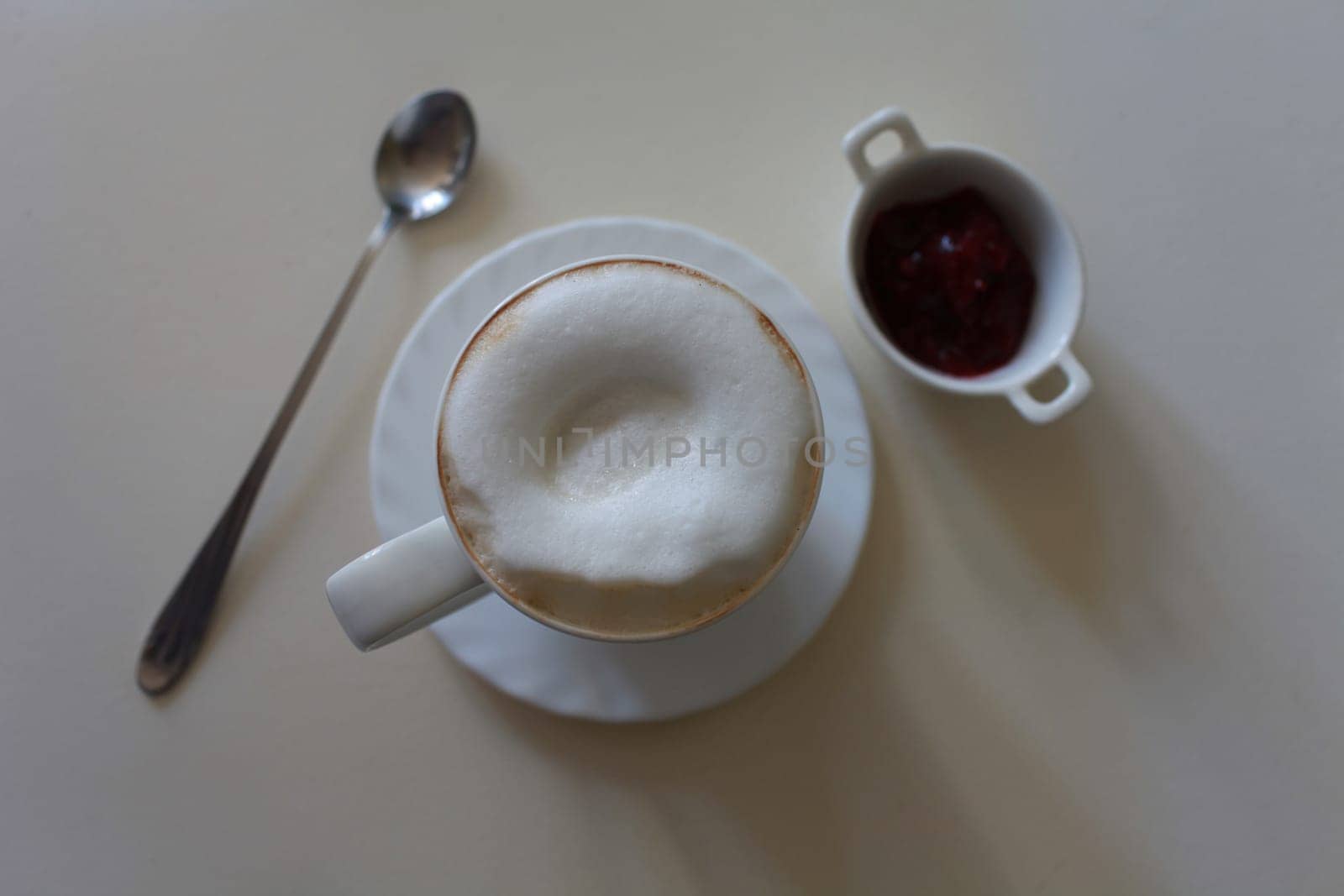 cup of cappuccino coffee with milk foam in the morning overhead shot