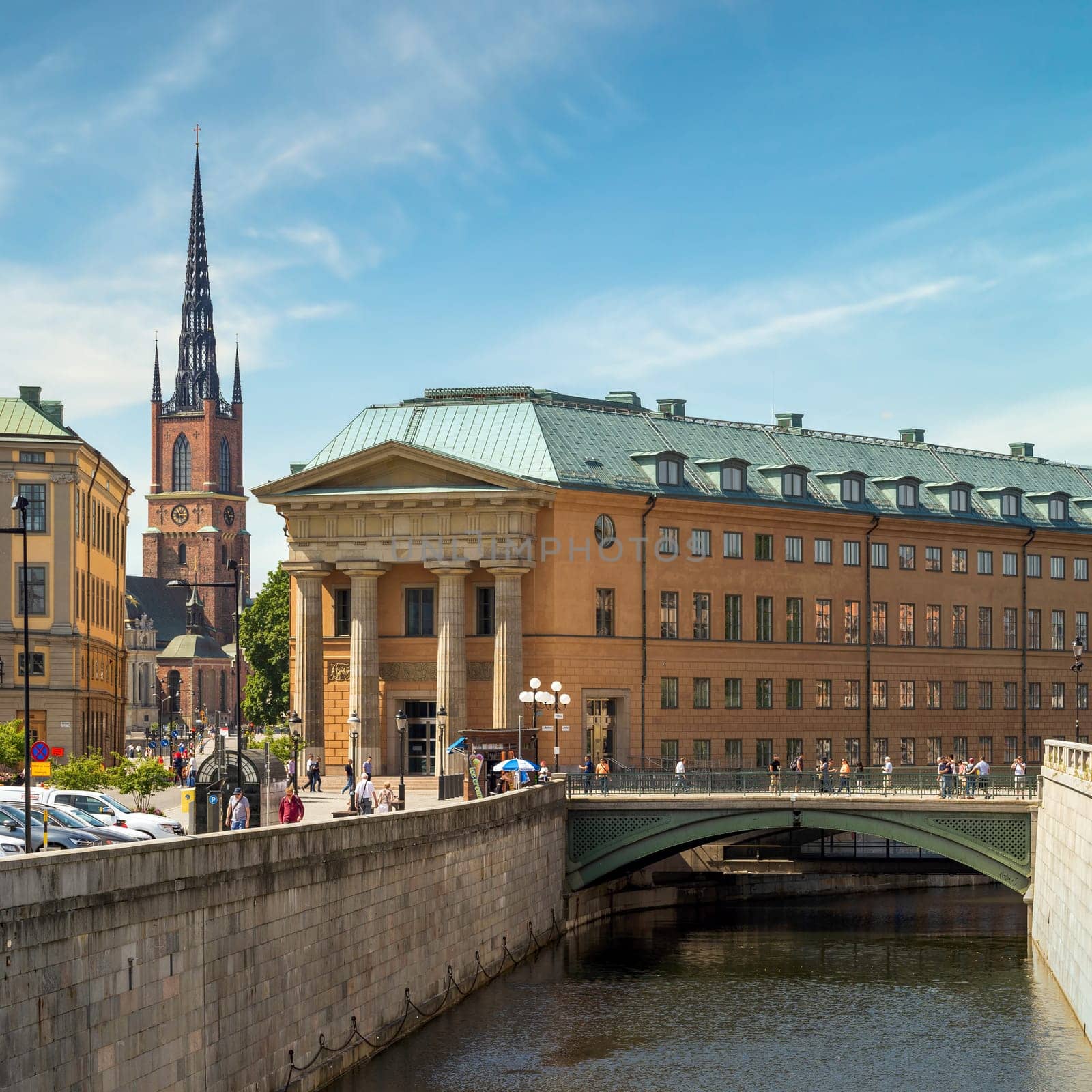 Stockholm, Sweden - June 26 2022: Sveriges Riksdag, Central authority of Sweden with tower of Klara Church in the far end, Old town, or Gamla Stan