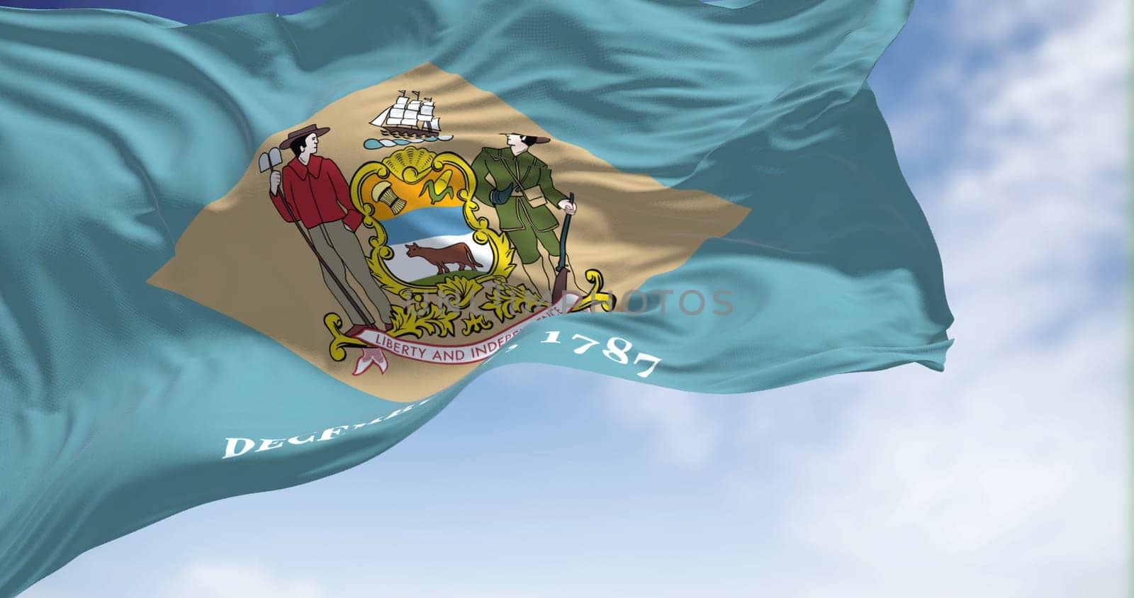 The state flag of Delaware waving in the wind on a clear day. Delaware is a state in the Mid-Atlantic region of the United States. Democracy and independence. US state.