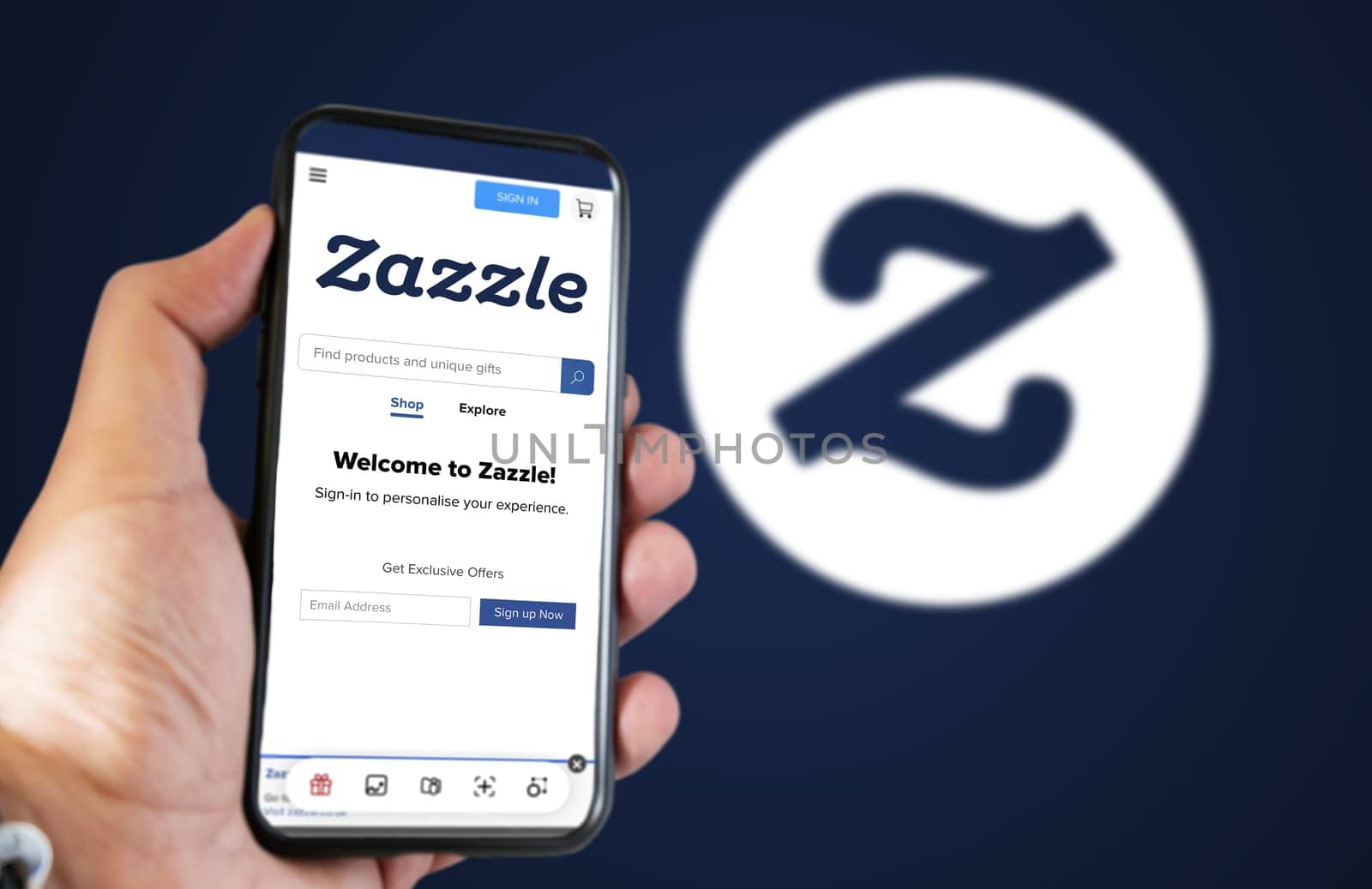 San Francisco, USA, June 2022: hand holding a phone with Zazzle homepage on the screen. Zazzle logo blurred on a blue background. Zazzle is an American online marketplace
