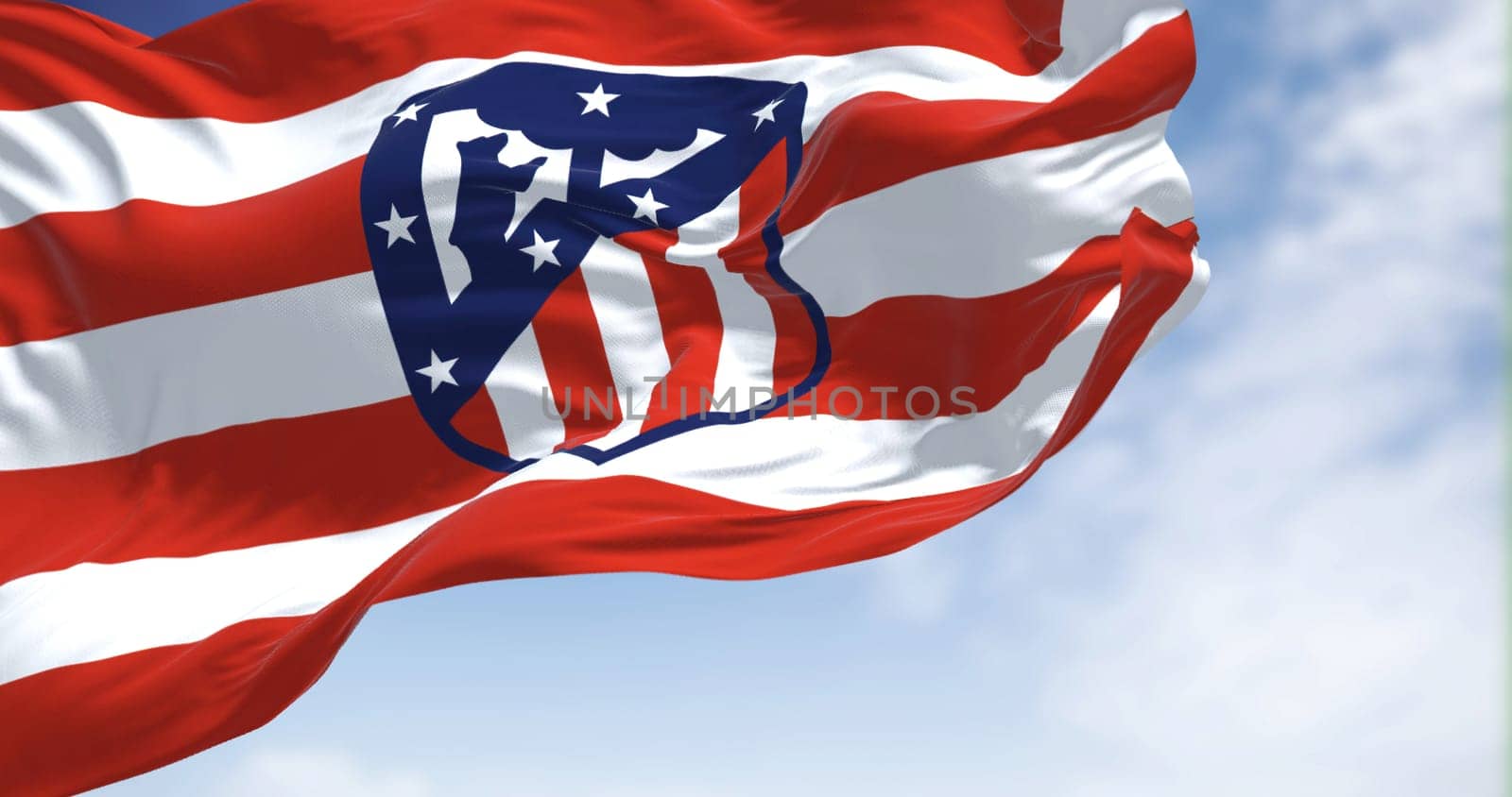 Madrid, Spain, May 2022: The flag of Atletico Madrid waving in the wind on a clear day. Atletico Madrid is a Spanish professional football club based in Madrid