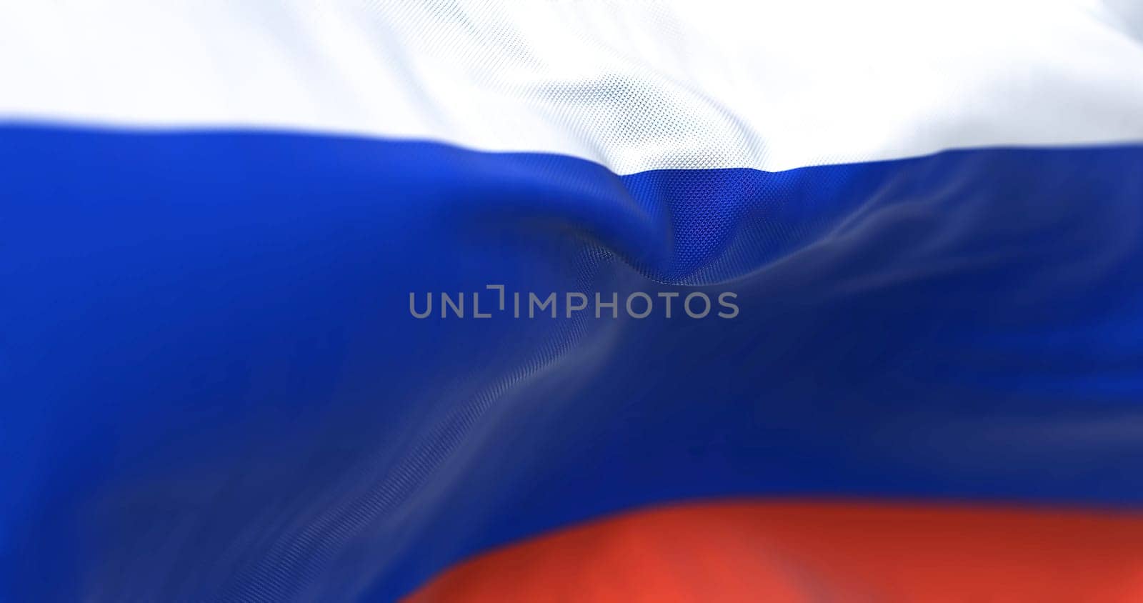 Close-up view of the Russian national flag waving in the wind. Russia is a transcontinental country spanning Eastern Europe and Northern Asia