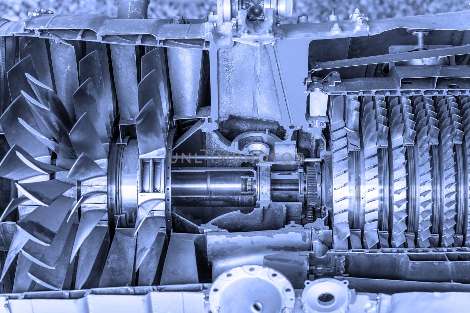 Front view of et engine cross section cutaway detail with a blue tint. Horizontally.