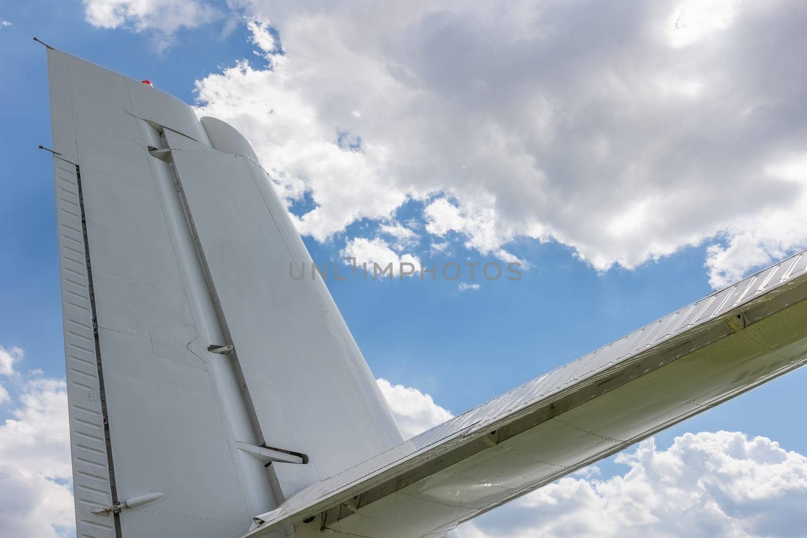 Travel concept of back wing of an airliner . Blue sky is in the background.