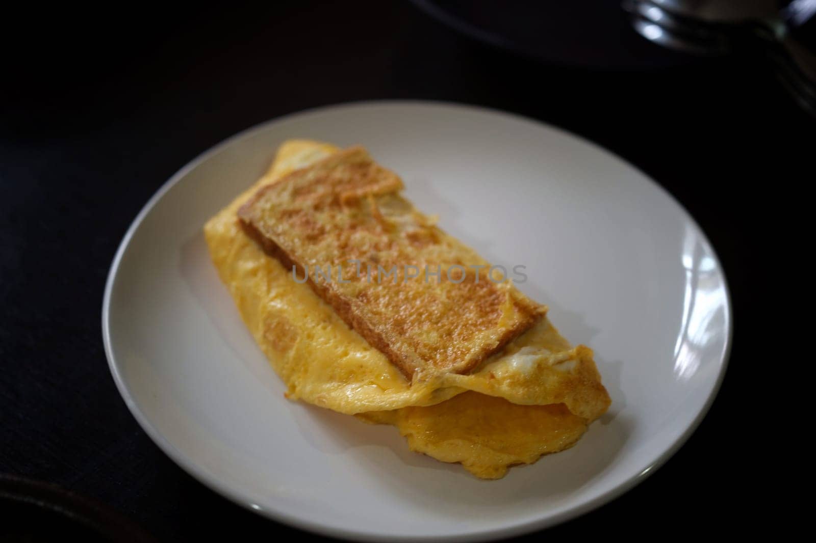 Sandwiches with egg, ham and toast cheese fried in white dish
