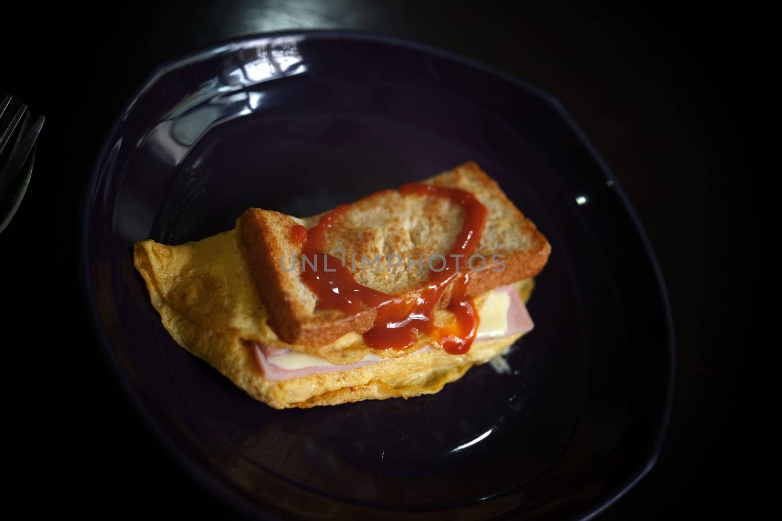 Sandwiches with egg, ham and toast cheese fried in dish