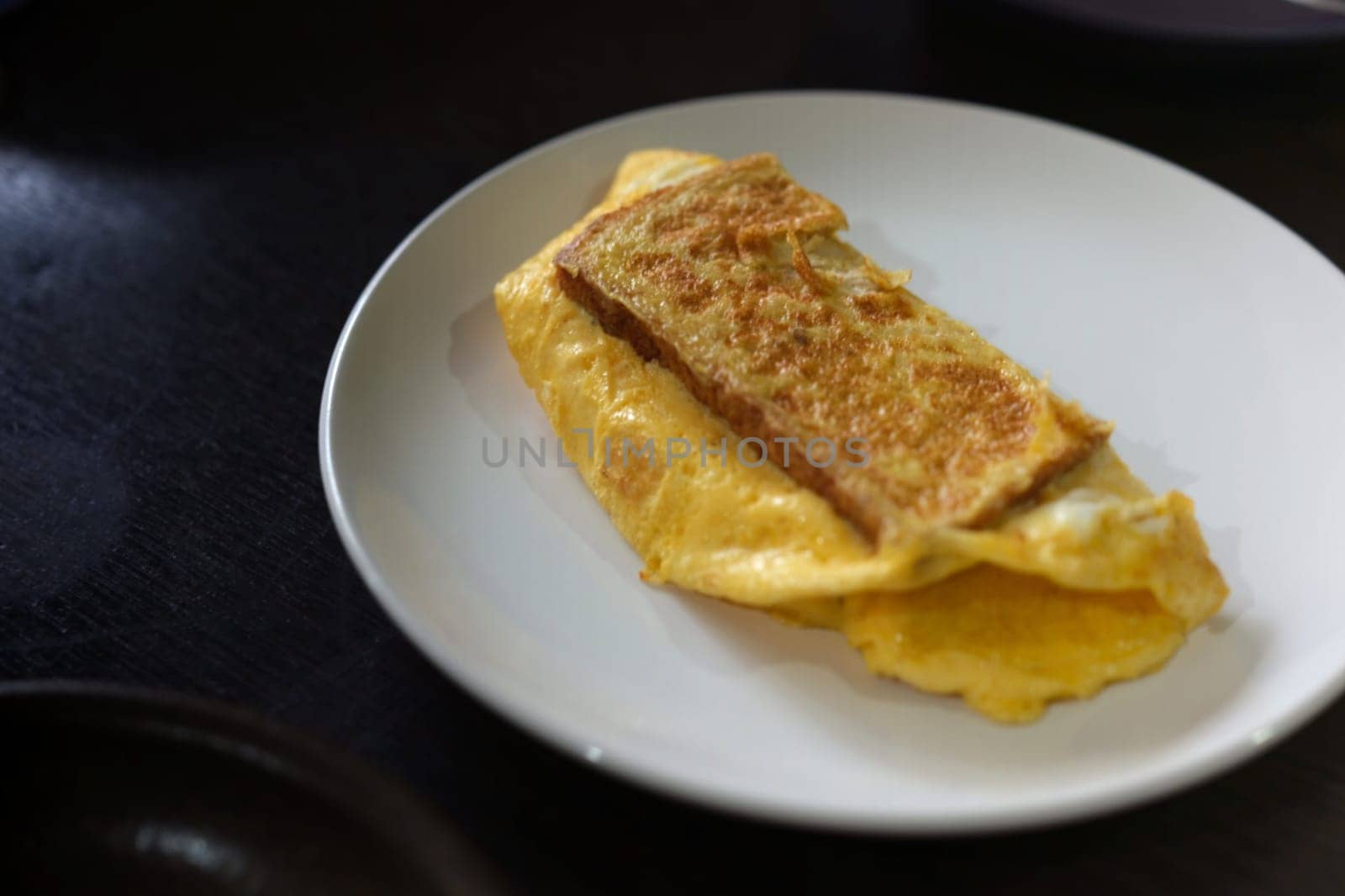 Sandwiches with egg, ham and toast cheese fried in white dish