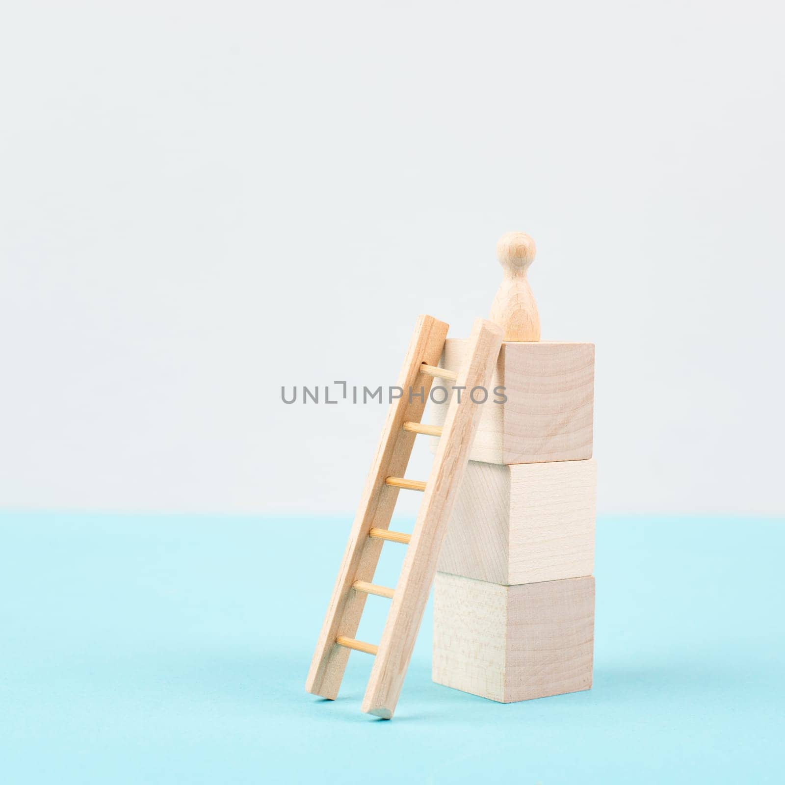 Man is standing next to a ladder, climbing up in career, having a goal, brainstorming for ideas, success strategy, taking a challenge, business concept