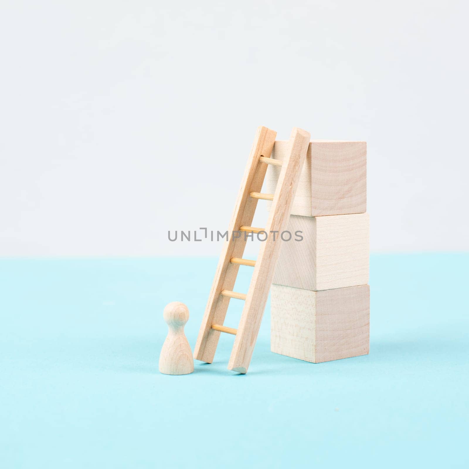 Man is standing next to a ladder, climbing up in career, having a goal, brainstorming for ideas, success strategy, taking a challenge, business concept
