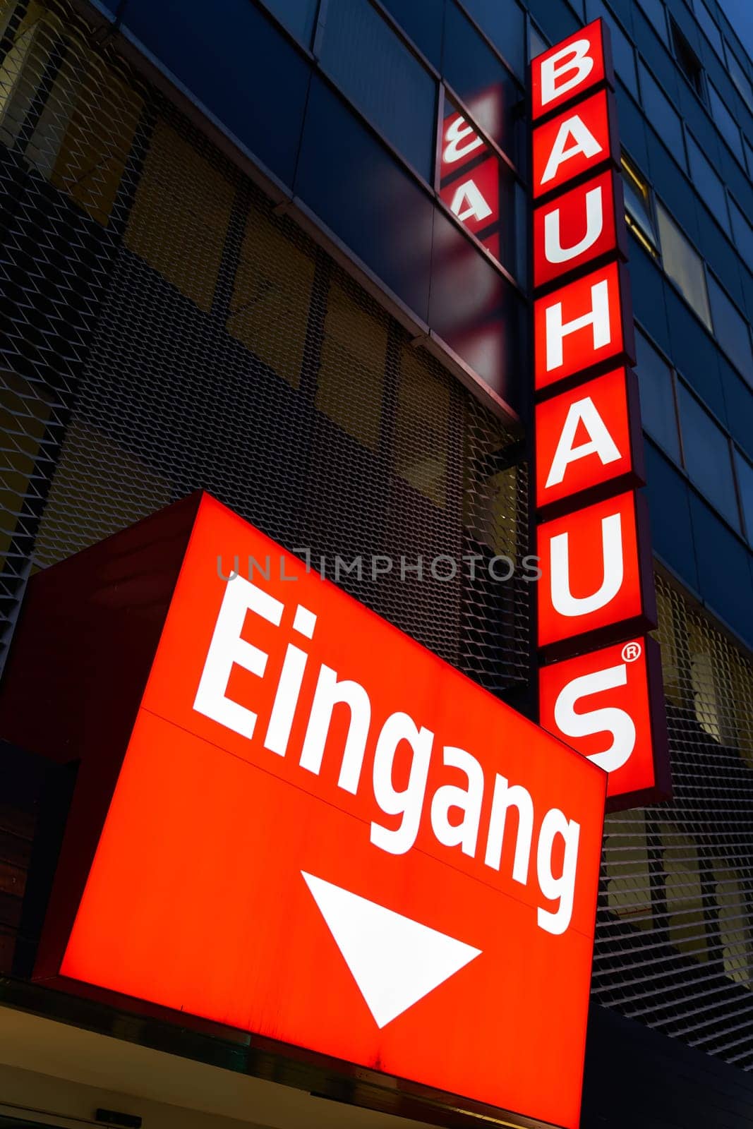 Illuminated advertising of the DIY chain Bauhaus AG on the facade of the DIY store in downtown Berlin