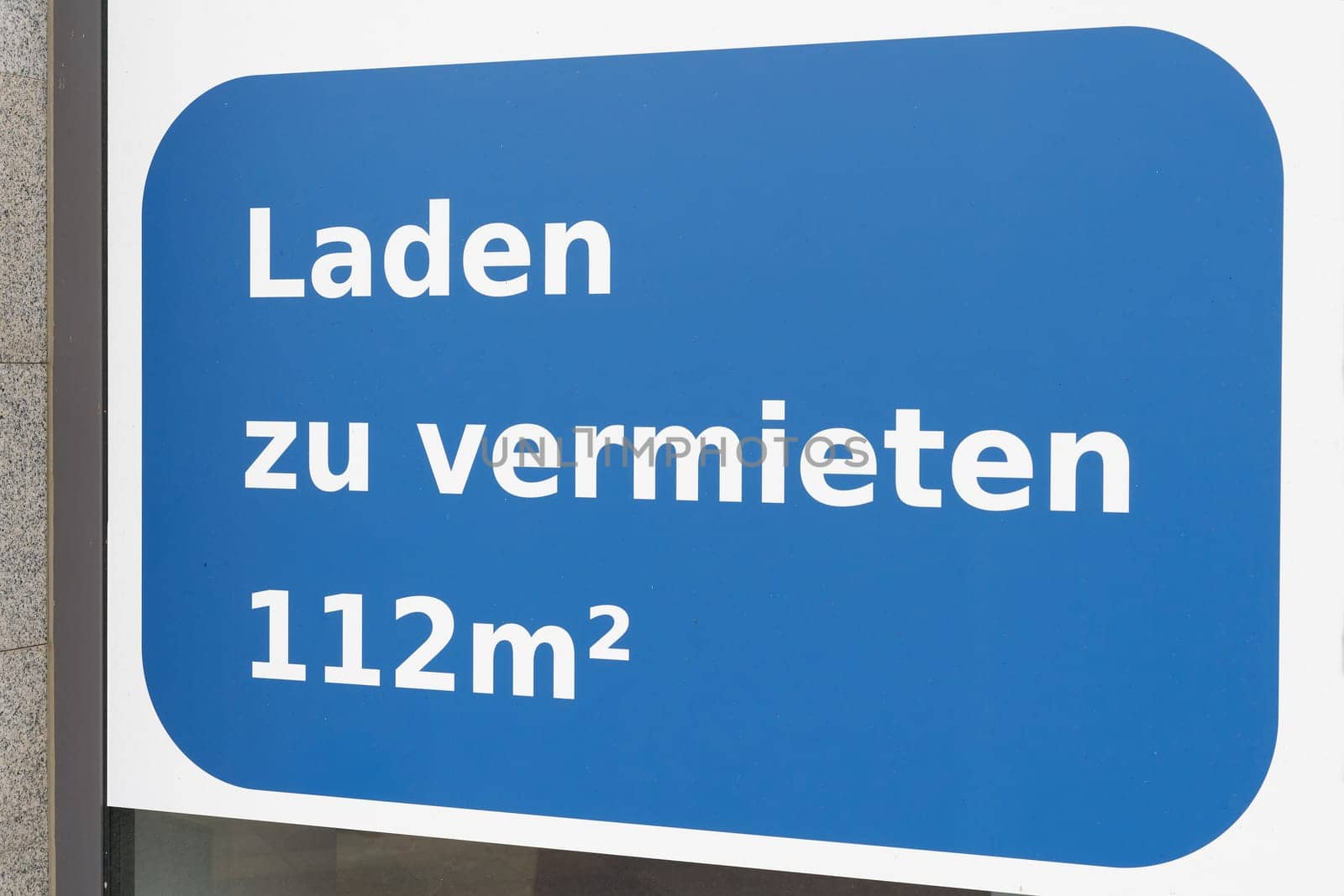 Sign on store window in Germany saying Laden zu vermieten. Translation: store for rent