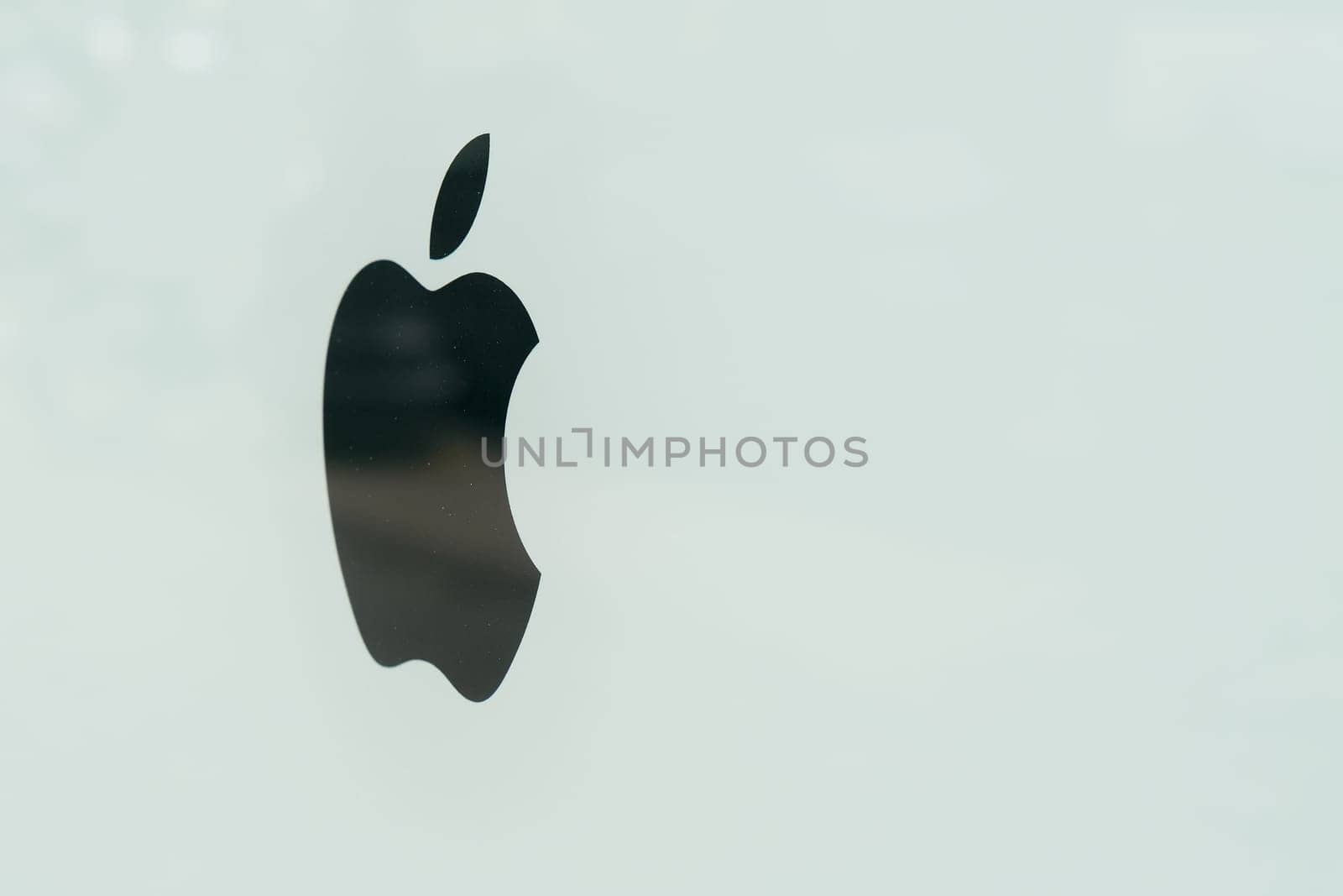 Logo of Apple company on a dirty shop window in downtown Berlin