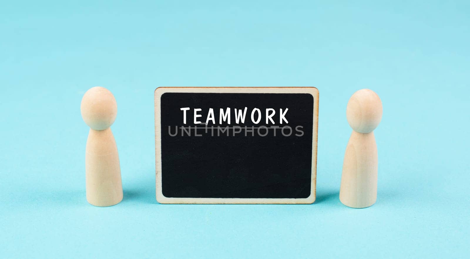 The word teamwork is standing on a chalkboard, working together, corporate in team, communication and support concept