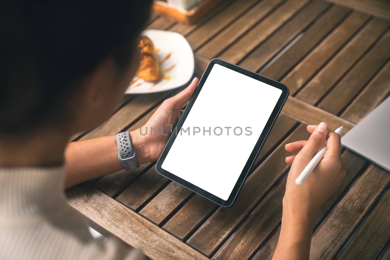 close-up women holding digital tablet white screen and stylus pen on table