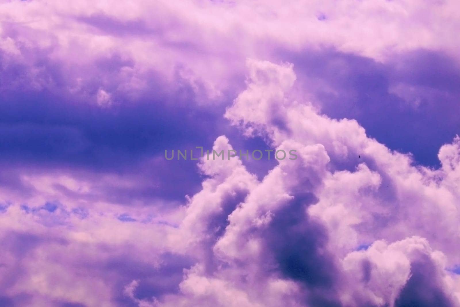 Beautiful pink storm clouds on a blue sky. Beauty of nature. Natural background..