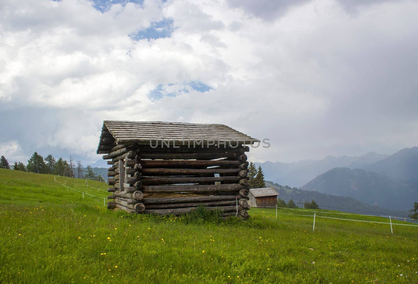 View of alpine landscape in summer with barn house surrounded by a green field.Lienzer Dolomiten, East Tyrol, Austria