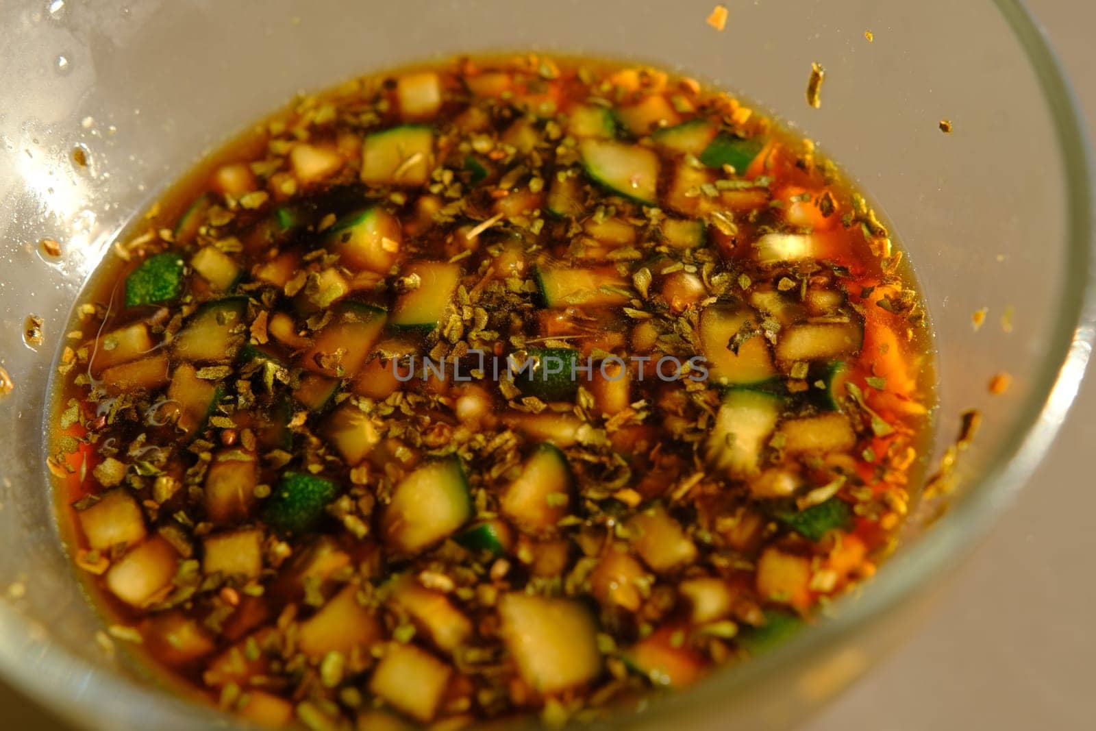 Soy sauce in a glass bowl with some vegetables