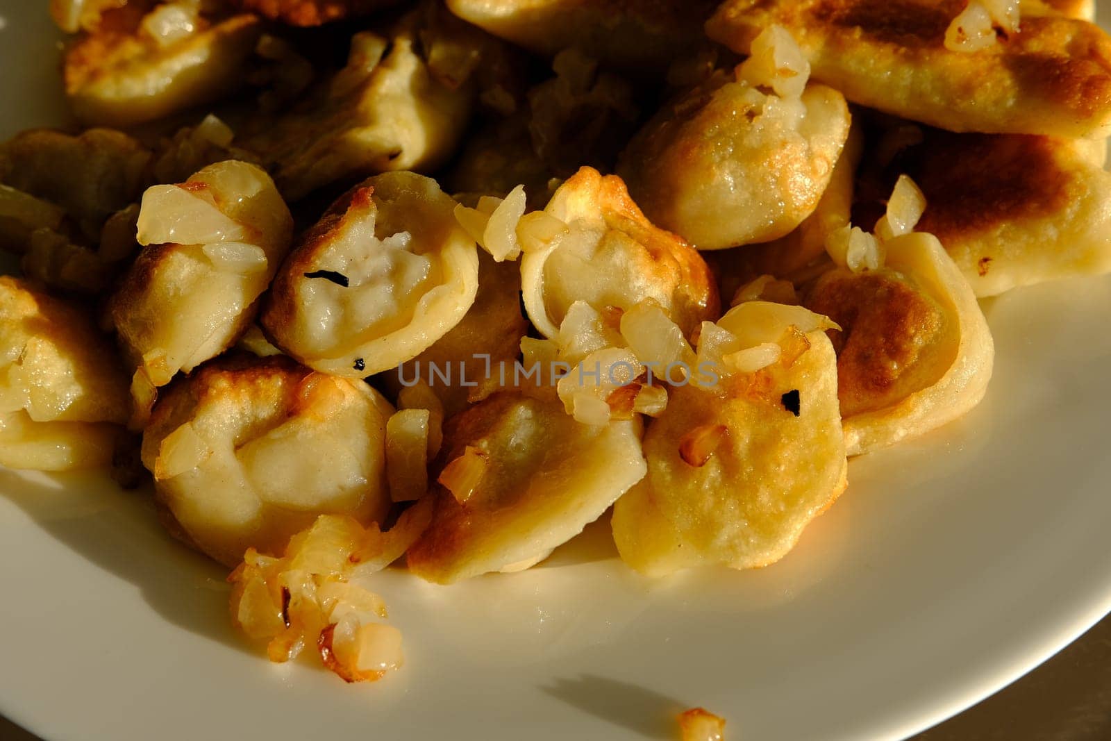 Homemade potato dumplings or vereniki pierogi, served with fried onions. Rustic style, comfort eastern europe cuisine.