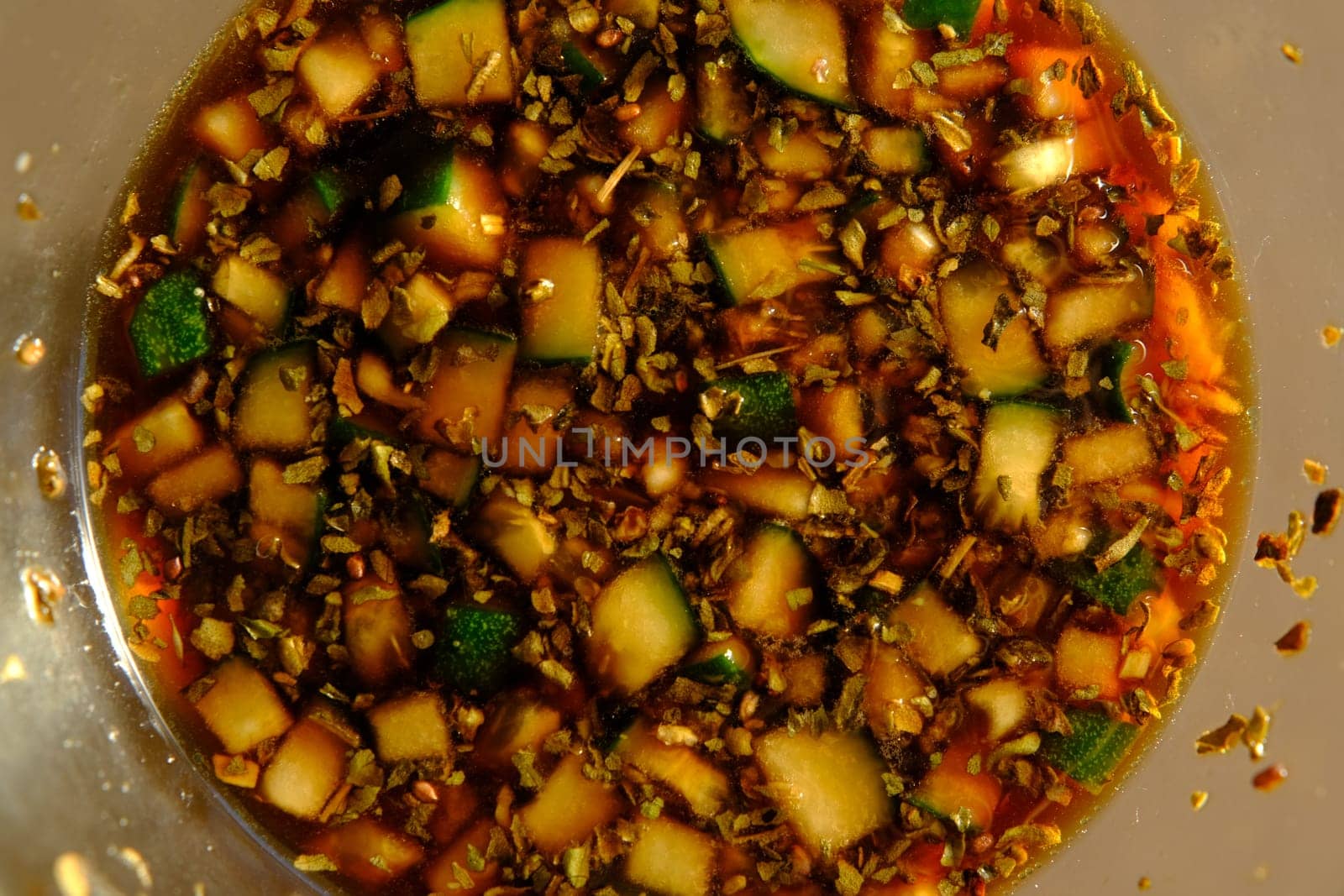 Soy sauce in a glass bowl with some vegetables