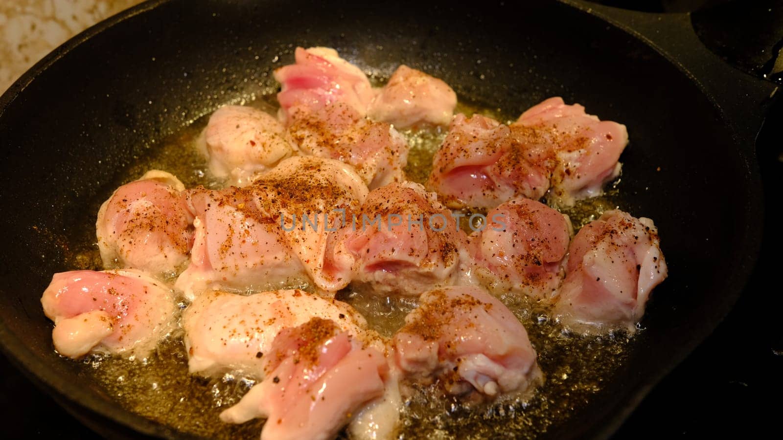 Delicious chicken in frying pan, in sunflower oil.