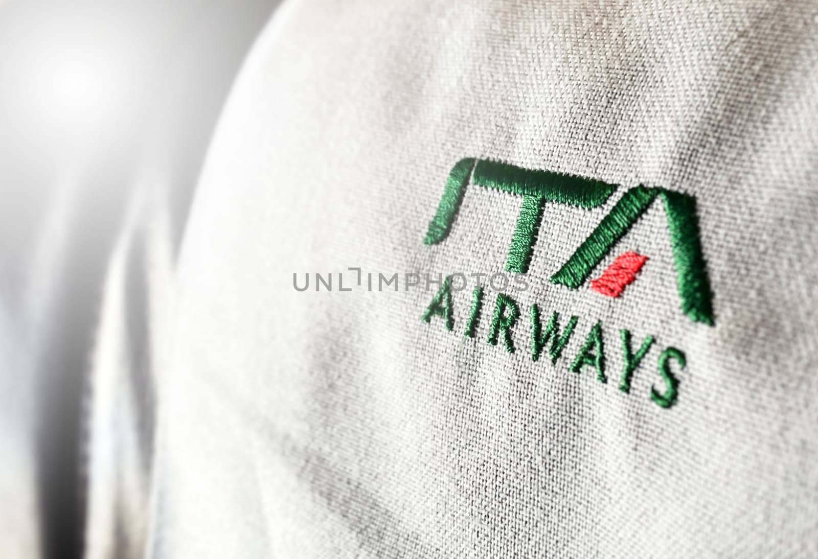 Rome, Italy, July 2022: The logo of the airline ITA Airways sewn on the headrest of an aircraft. ITA Airways is the Italian flag carrier