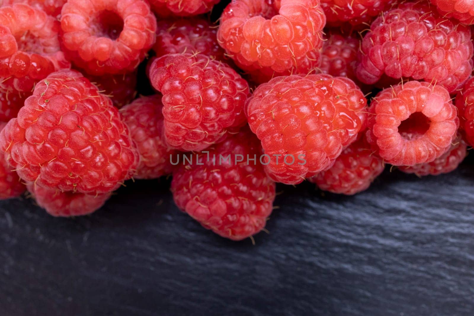Fresh raspberry summer juicy fruits for a healthy diet. Organic raspberries for a healthy food and life concept.