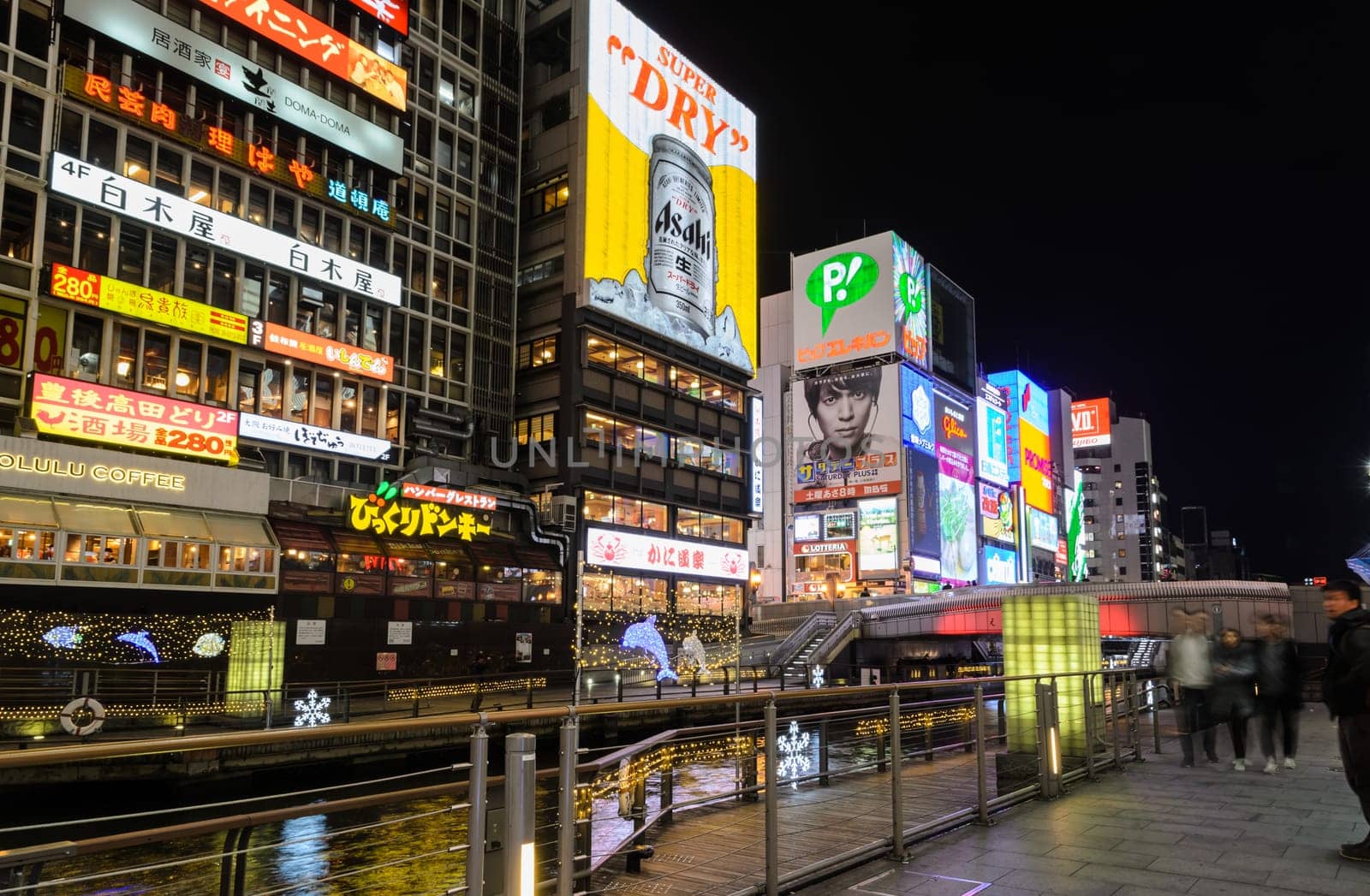 OSAKA, JAPAN - NOVEMBER 23, 2016 : The Asahi Breweries billboard and other illuminated signboards in Dontonbori, Namba area, Osaka, Japan. Dotombori is popular nightlife and entertainment area in Osaka.