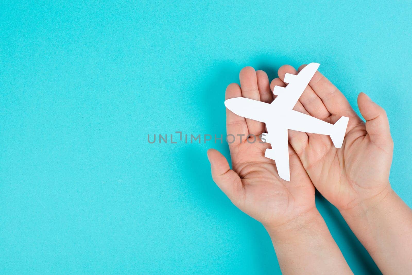 Holding an airplane in the hands, taking a flight, planning a vacation