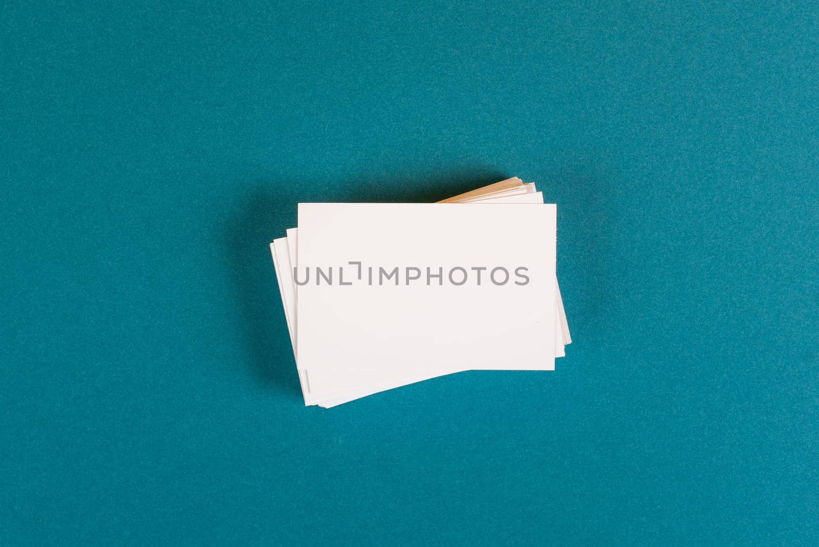 Blank white papers with a paperclip on a gray colored background, copy space for text, reminder or message in the office, communication concept