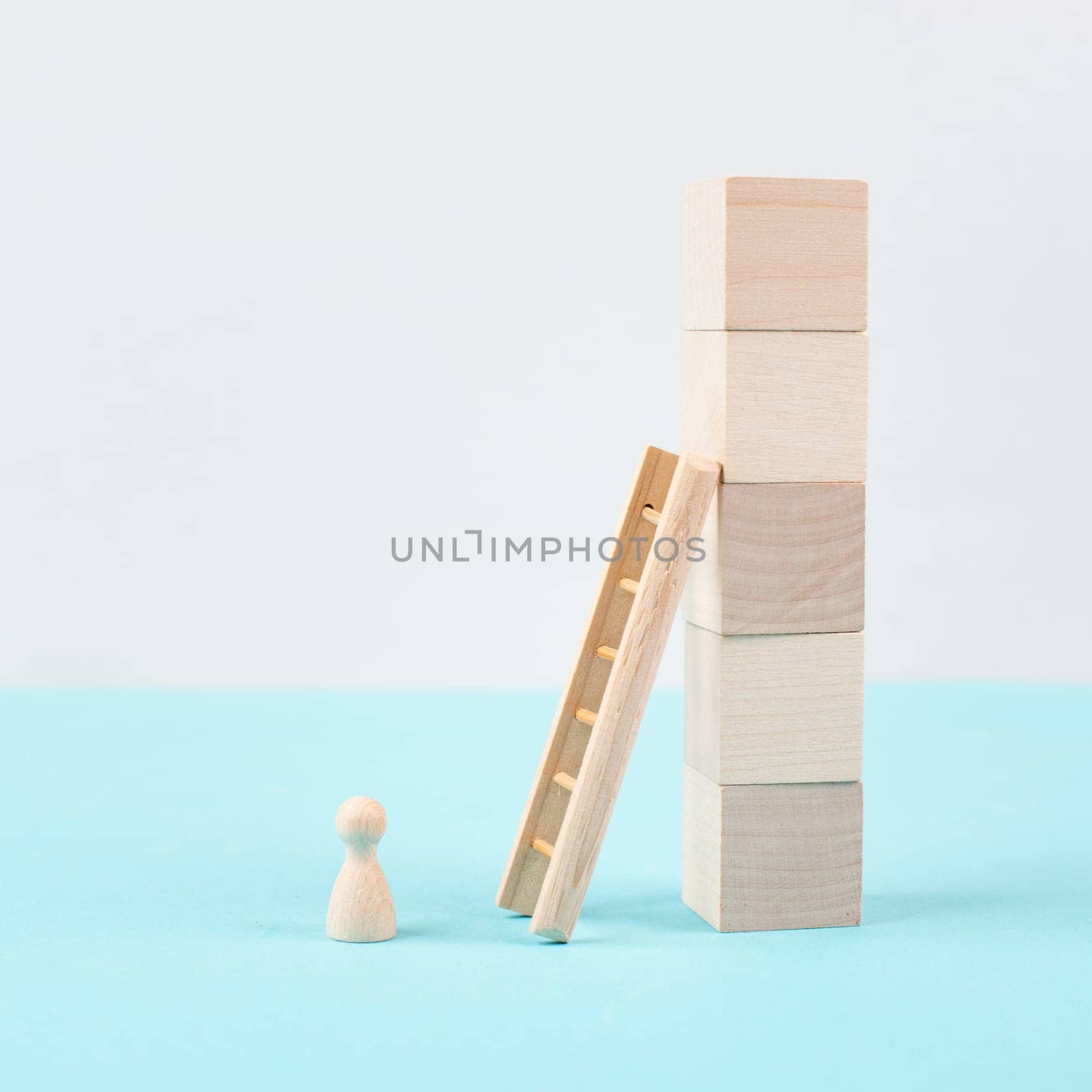 Man is standing next to a ladder, climbing up in career, having a goal, brainstorming for ideas, success strategy, taking a challenge, business concept