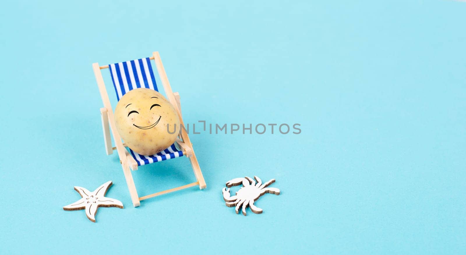 Potato with a funny face is sitting in lounge chairs, happy holiday, greeting card