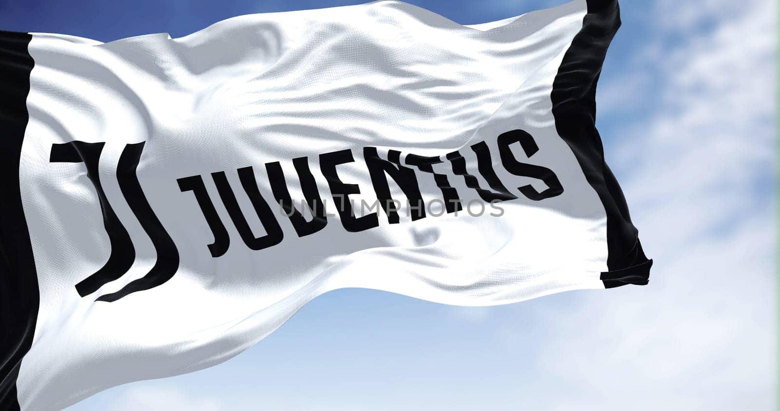 Turin, Italy, July 2022: The flag of Juventus Football Club waving. Juventus is a professional football club based in Turin. Italy