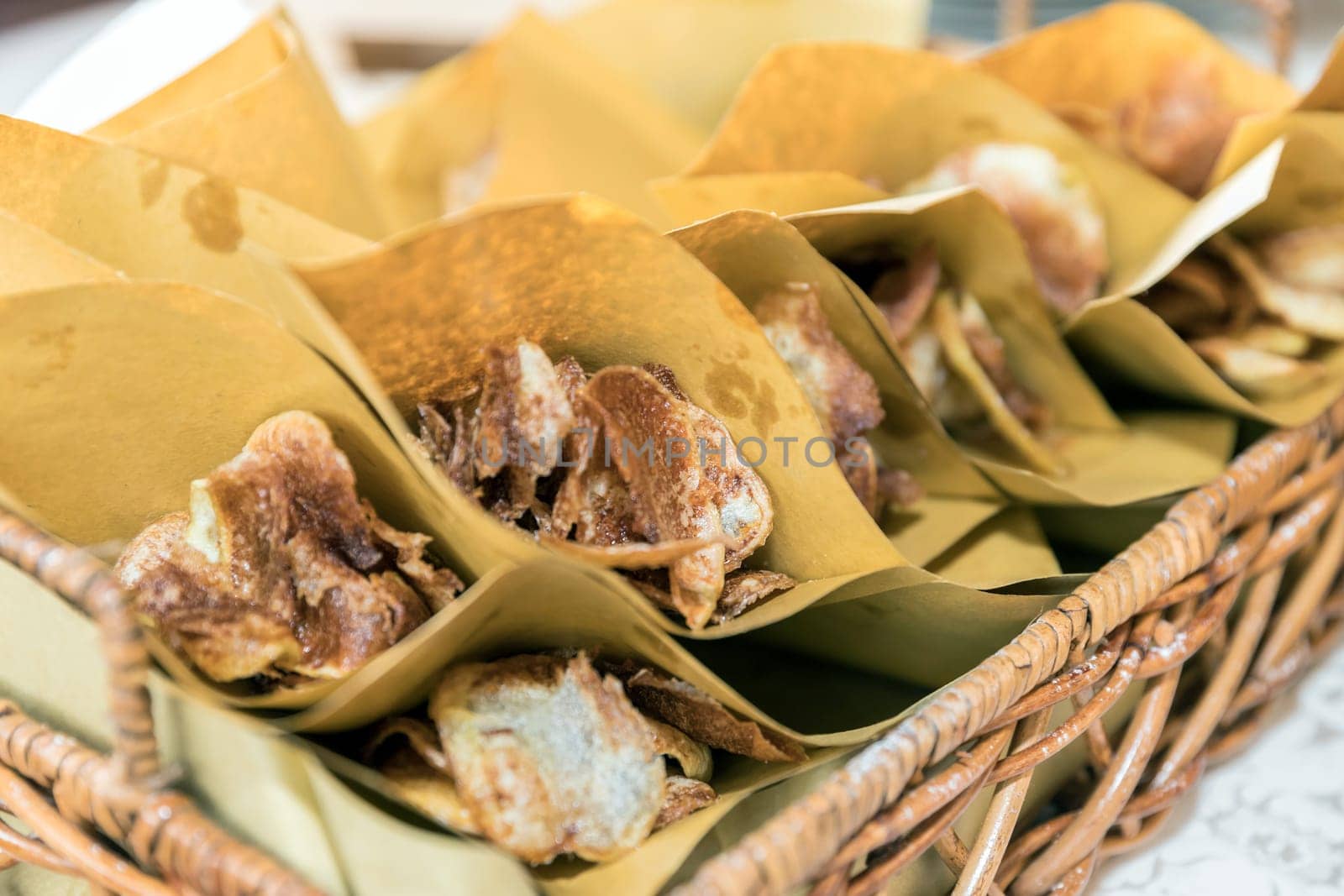 French fries in paper cones, one on top of the other.