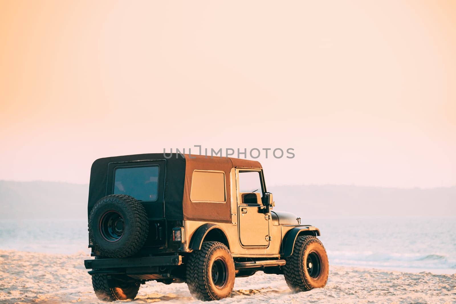 Black SUV Car On Off Road In Sea Beach Landscape In India. Drive And Travel Concept.