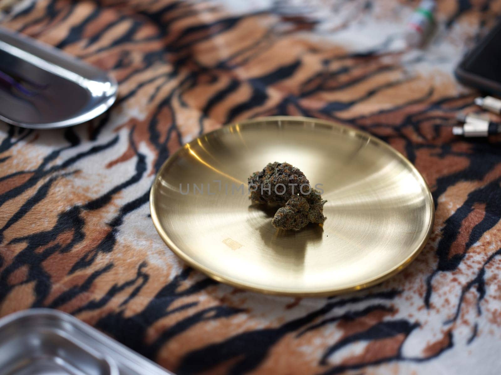 Medical marijuana flower buds. Recreational marijuana strain. Cannabis strain. Weed bud in brass dish.