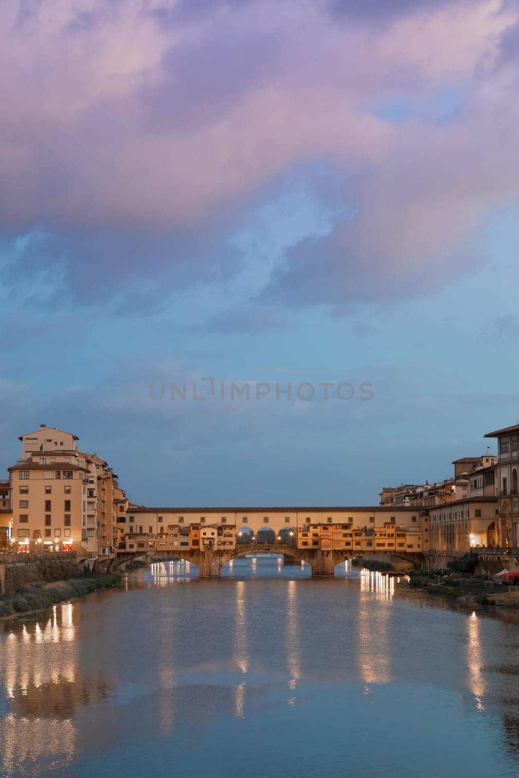 Florence, Italy - circa July 2021. Sunset light on Ponte Vecchio - Old Bridge.