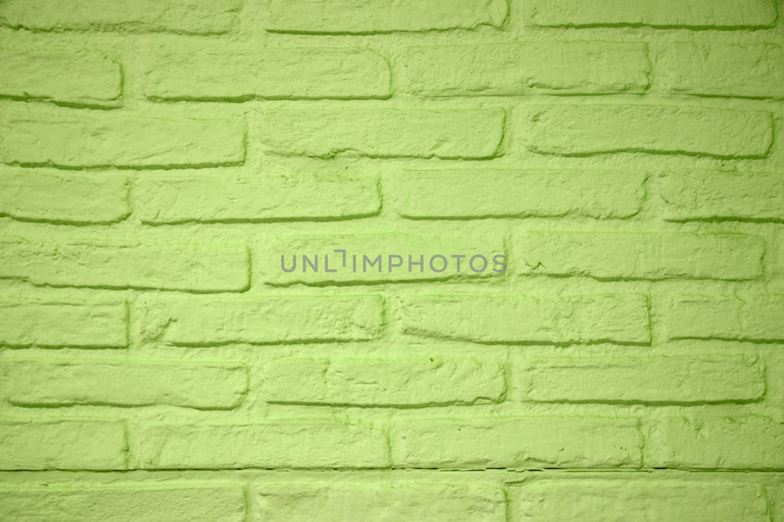 Stone texture background. Closeup of a green brick wall texture. Abstract brick stones pattern background concept, retro layout, interior design and wall banner.
