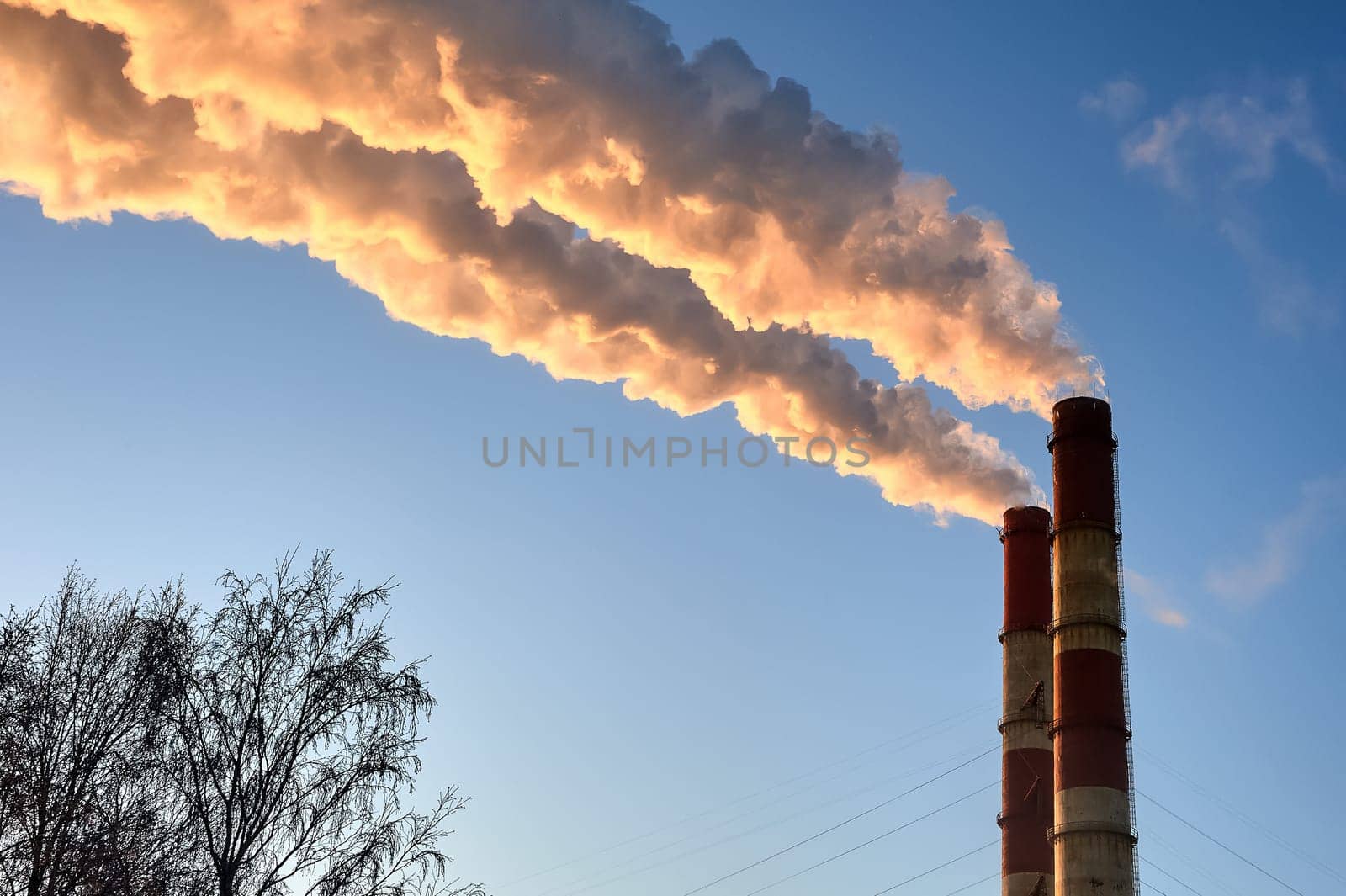white smoke is coming out of the pipes in the blue sky. High quality photo