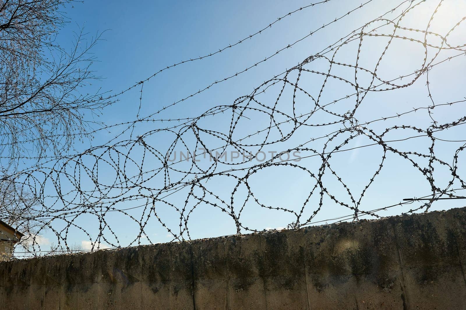 Barbed wire on a blue sky background. High quality photo