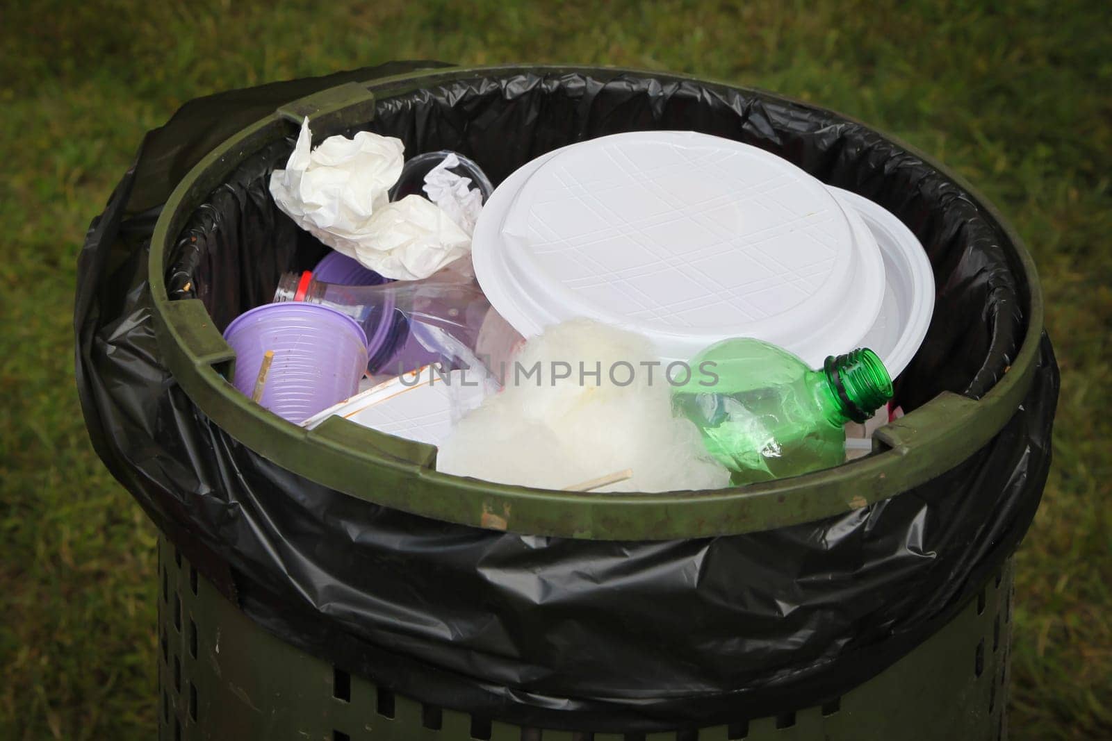 A Black garbage bag in a park