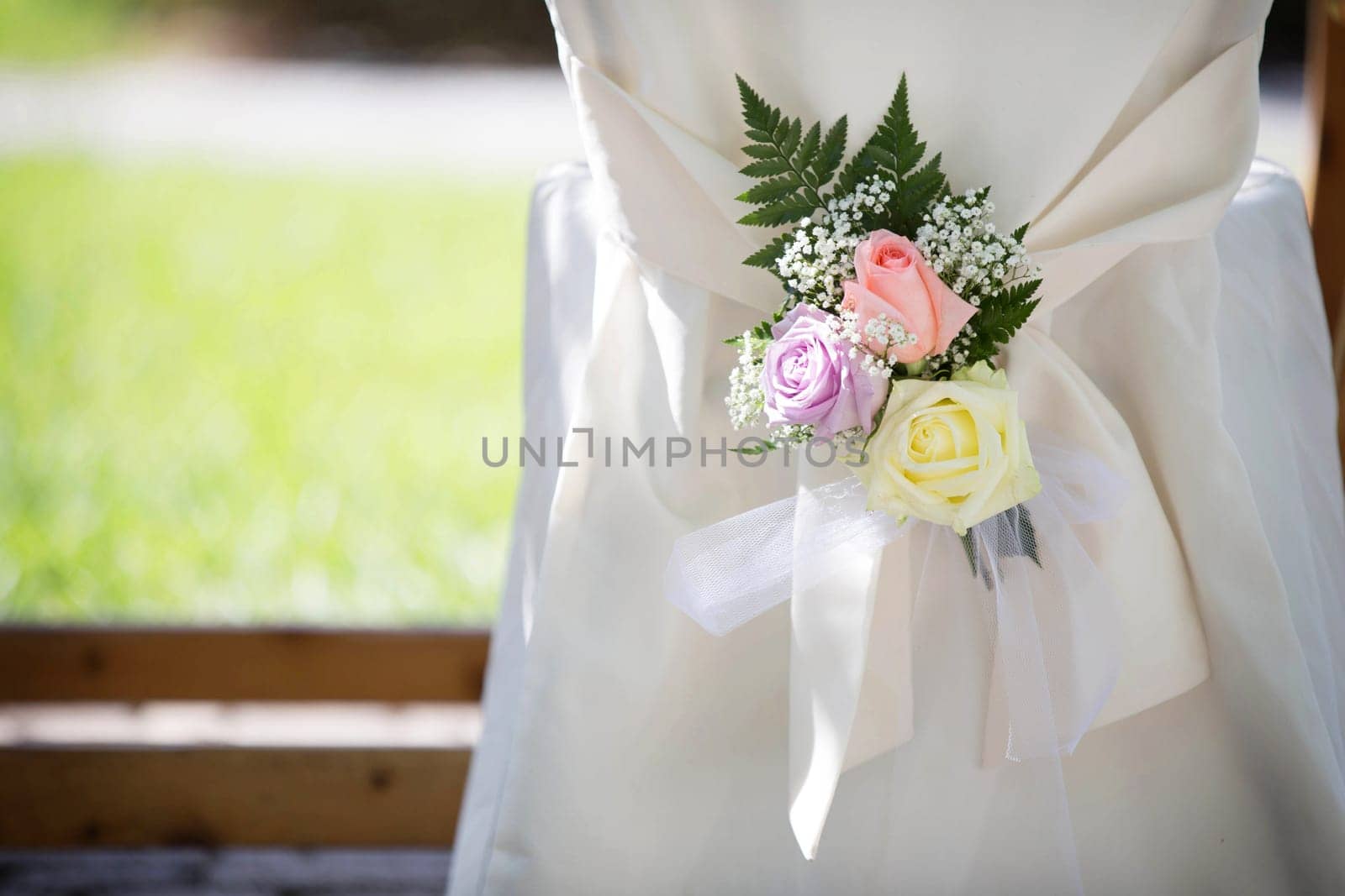 Wedding Chair Cover with Fresh Roses in a Wedding Day
