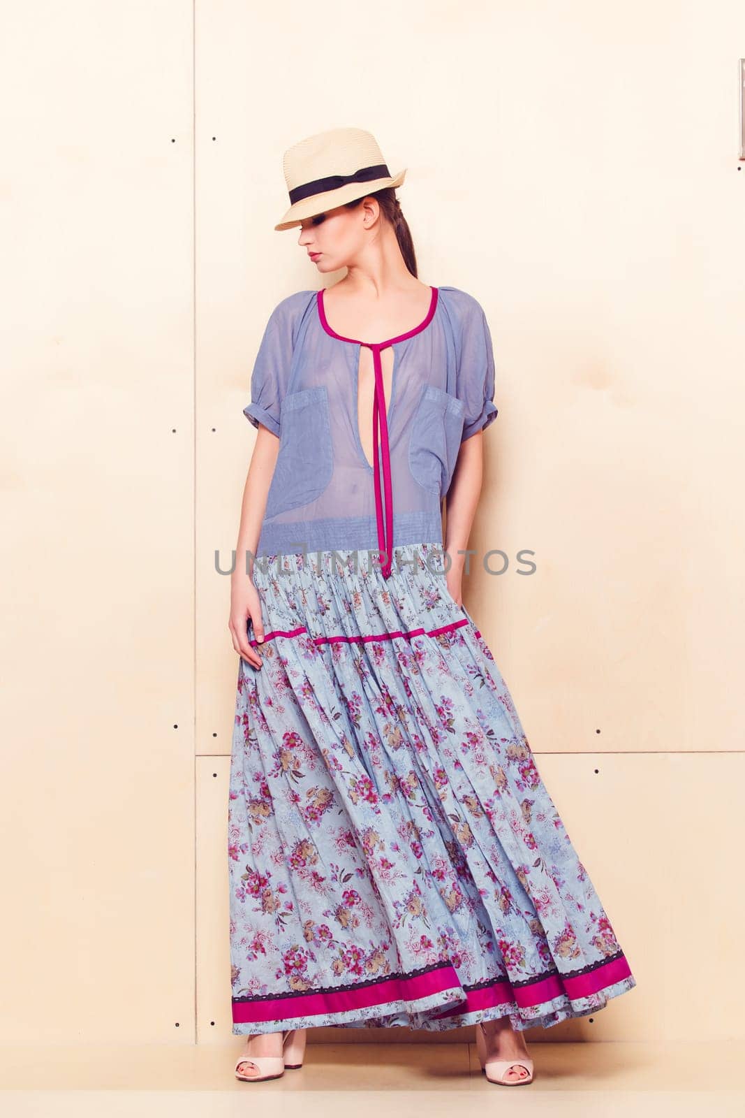 Full-length portrait of a lovely woman in romantic dress on wodden background