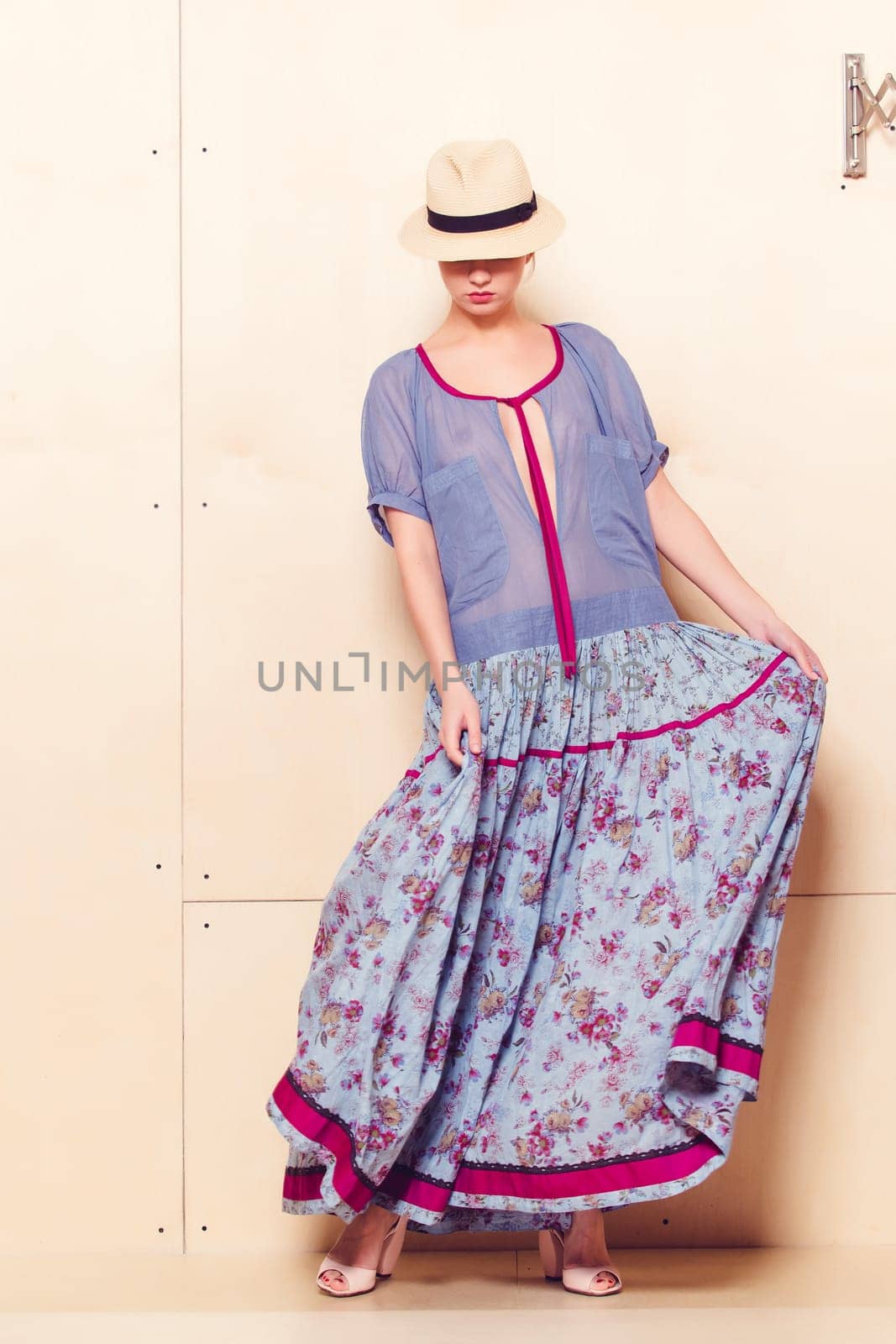 Full-length portrait of a lovely woman in romantic dress on wodden background